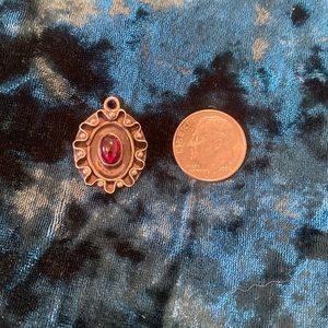 Sterling silver and garnet pendant.